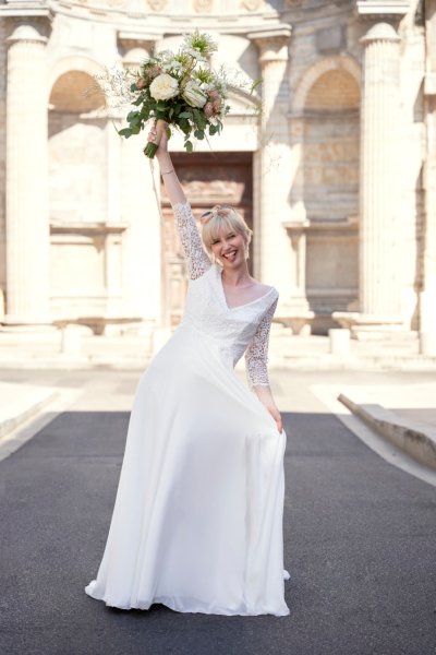 Bride wedding dress lace on her own street style sunglasses glasses bouquet flowers