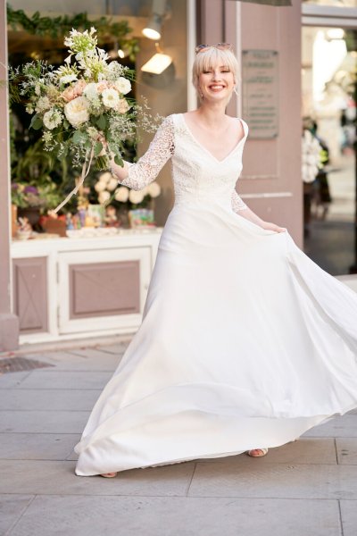 Bride wedding dress lace on her own street style sunglasses glasses bouquet flowers