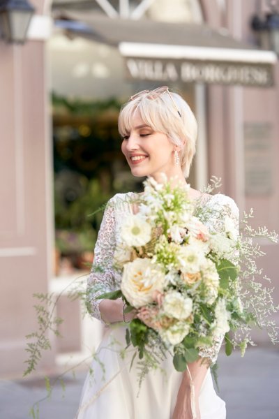 Bride wedding dress lace on her own street style sunglasses glasses bouquet flowers