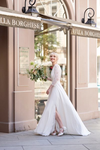 Bride wedding dress lace on her own street style sunglasses glasses bouquet flowers