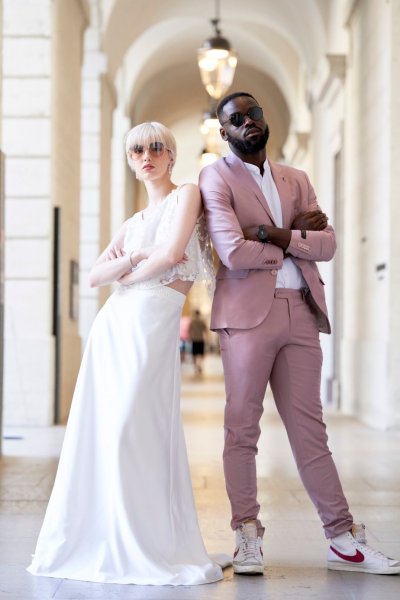 Bride groom pink suit arms folded