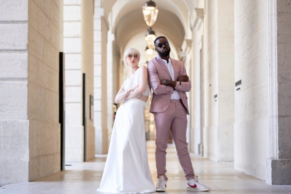 Bride groom pink suit arms folded