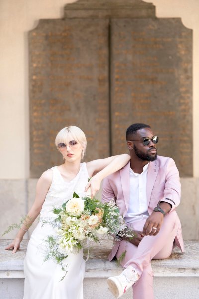 Bride groom pink suit bouquet flowers sunglasses glasses exterior