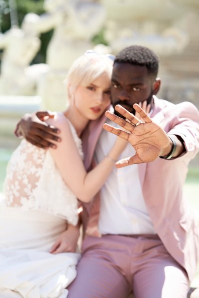 Bride groom pink suit at fountain