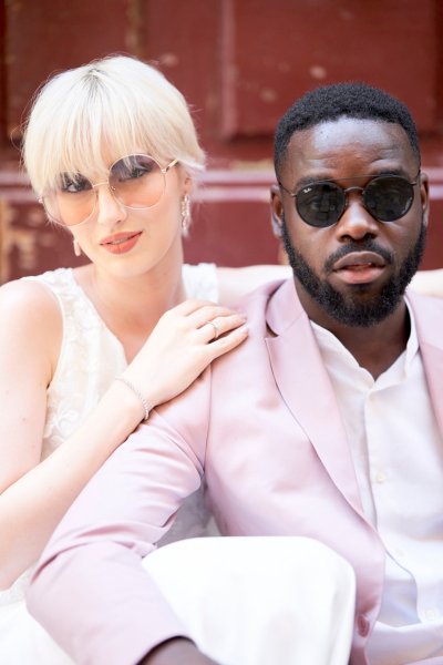 Groom bride wearing sunglasses pink suit