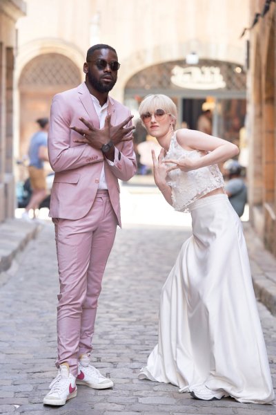 Bride groom pink suit lace dress walking down street