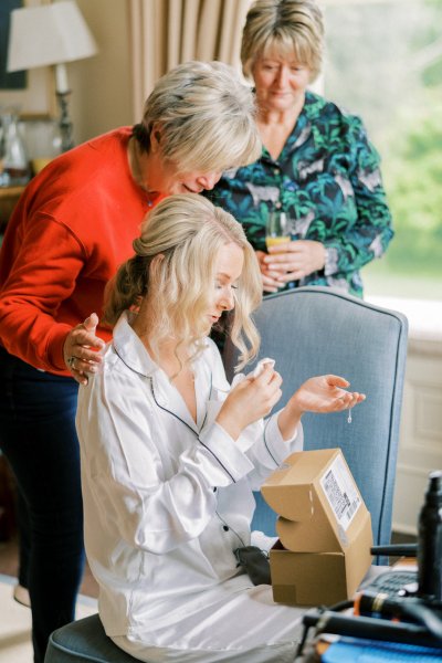 Bride getting ready hair hairstyle opening gift