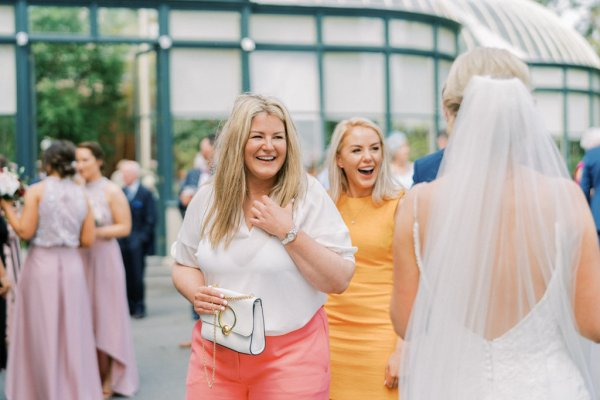 Laughing guests with bride