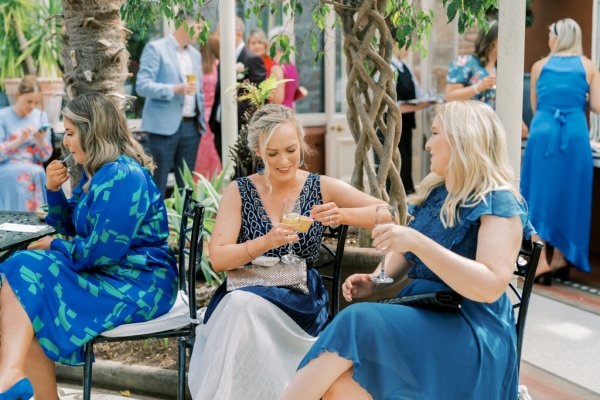 Guests wearing blue celebrate wedding