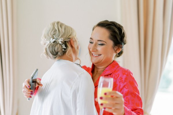 Bridesmaids and bride drinking orange juice prosecco