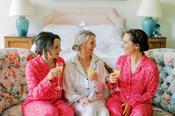 Bridesmaids and bride drinking orange juice prosecco