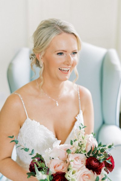 Bride hold pink red roses bouquet of flowers