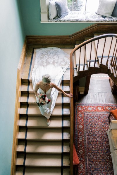 Bride makes her way to ceremony down the stairs