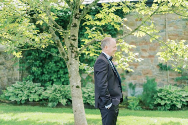 Groom waiting for bride in garden