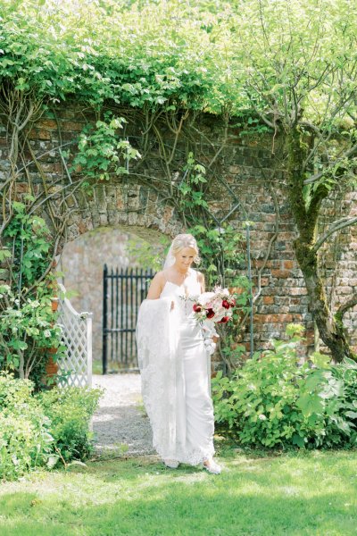 Bride on her way to groom in garden