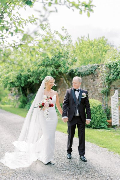 Bride groom flowers pink red bouquet walking