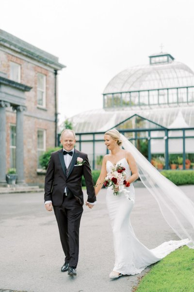 Bride groom garden park roses flower bouquet veil blowing in the wind