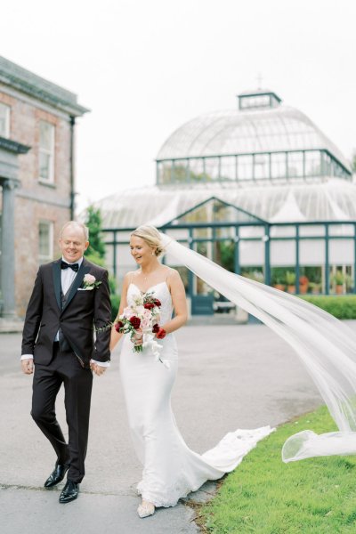 Bride groom garden park roses flower bouquet veil blowing in the wind