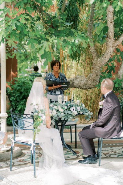 Bride groom officiant officiate wedding ceremony sitting