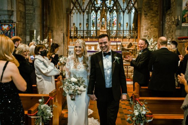 Bride groom exit the church guests clapping