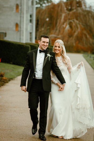 Bride groom exterior forest park long train flowers bouquet