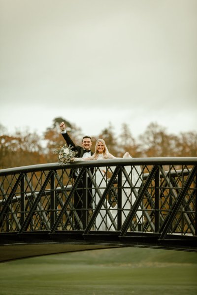 Bride groom on black bridge winter forest