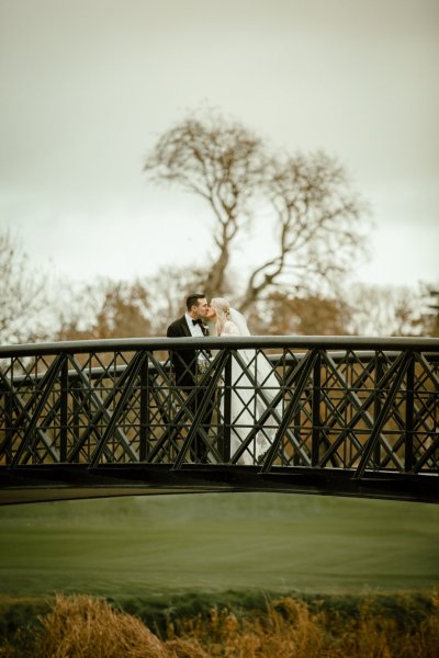 Bride groom on black bridge winter forest