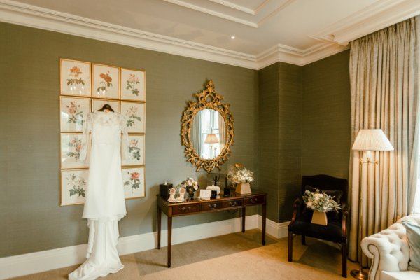 White wedding dress hanging in room