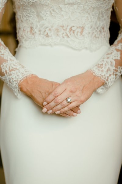 Close up of wedding ring lace white dress