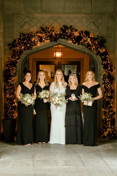 Bride and bridesmaids holding bouquet of flowers