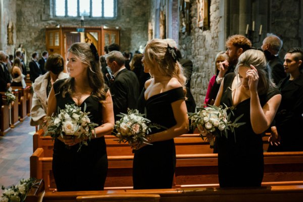 Guests in pew bridesmaids guests