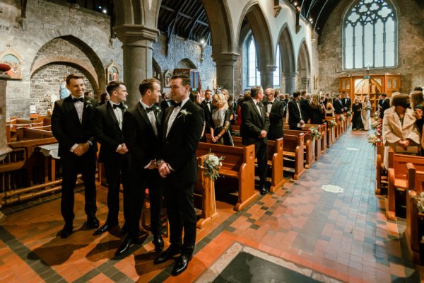 Groom groomsmen alter church guests