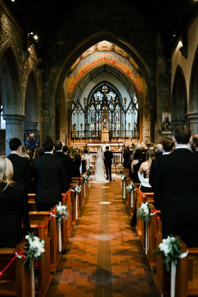 Bride and groom at the alter guests church