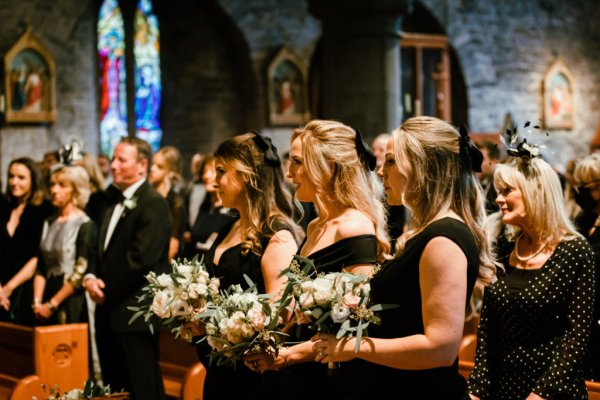 Black bridesmaids dresses blonde flowers bouquet