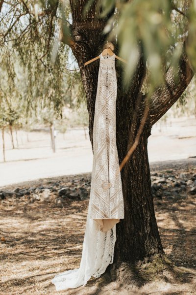 Wedding dress hanging outside forest park