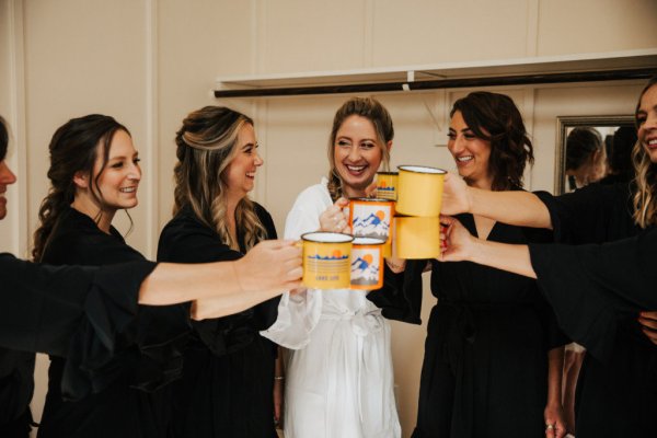 Bride bridesmaids dressing robes cheers prosecco