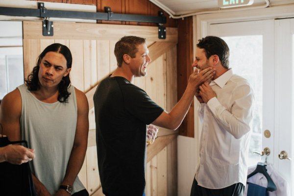 Groom getting ready suit and tie groomsman