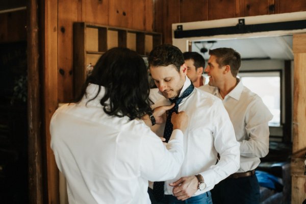 Groom getting ready suit and tie groomsman