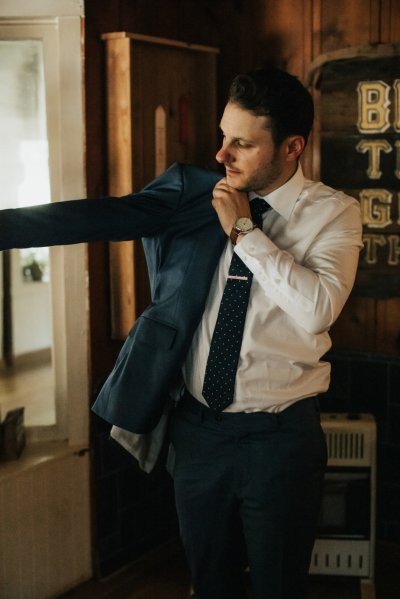 Groom getting ready suit and tie