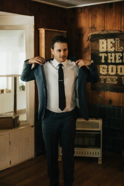 Groom getting ready suit and tie