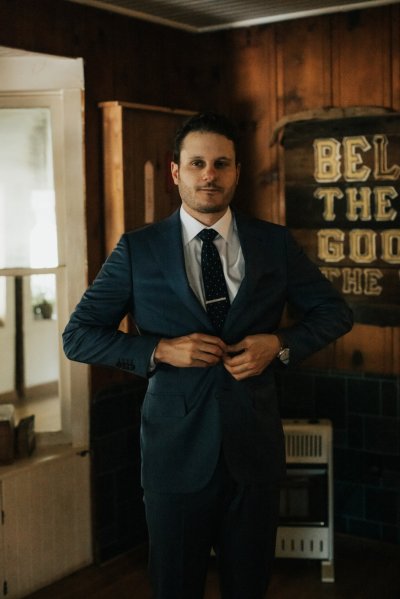 Groom getting ready suit and tie