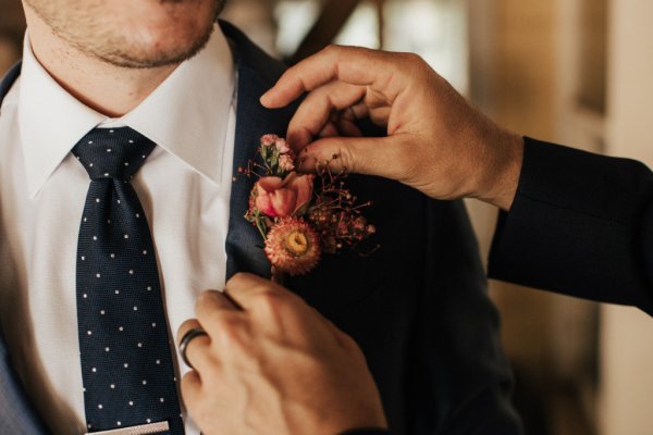 Groom suit tie smiling flower