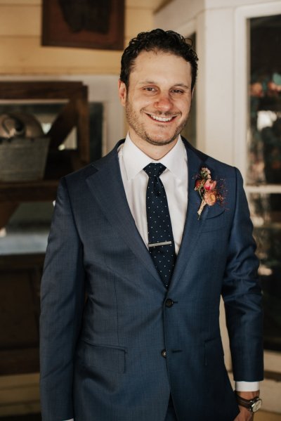 Groom suit tie smiling flower