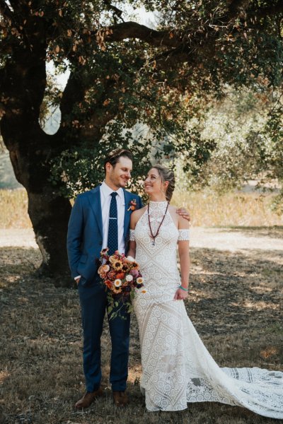 Bride groom forest park tree sunshine bouquet flowers