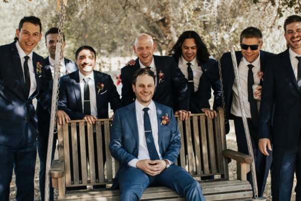 Groom groomsmen sitting on bench