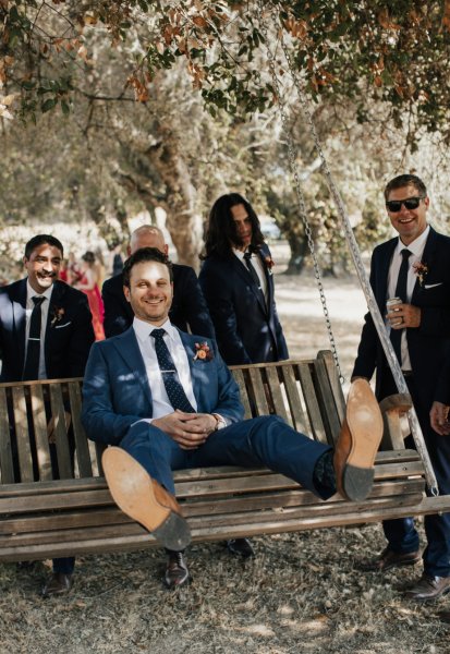 Groom groomsmen sitting on bench