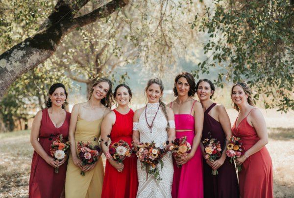 Bride bridesmaids red pink dresses flowers bouquet