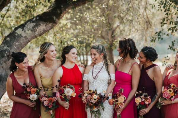 Bride bridesmaids red pink dresses flowers bouquet