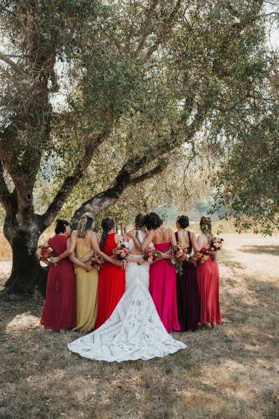 Bride bridesmaids red pink dresses flowers bouquet