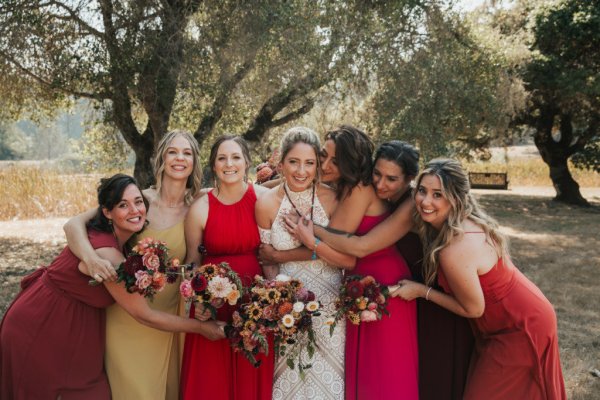 Bride bridesmaids red pink dresses flowers bouquet